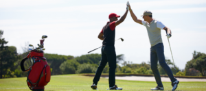 2 golf players high-fiving each other after a good game.
